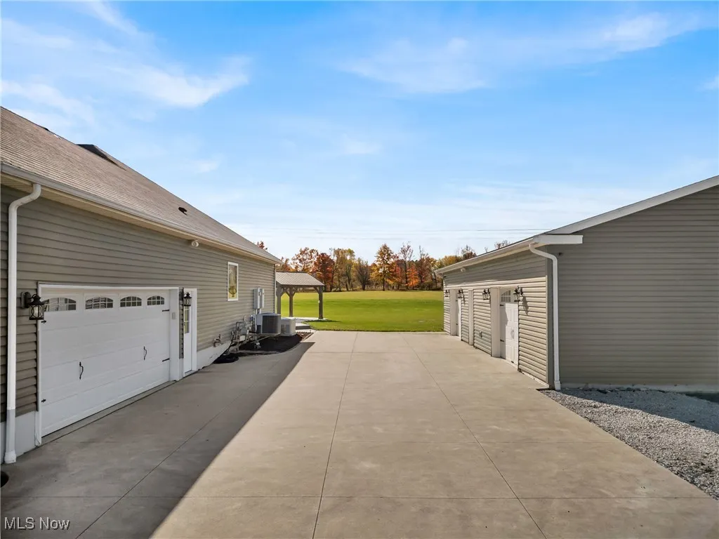 View of patio / terrace with a gazebo and a garage