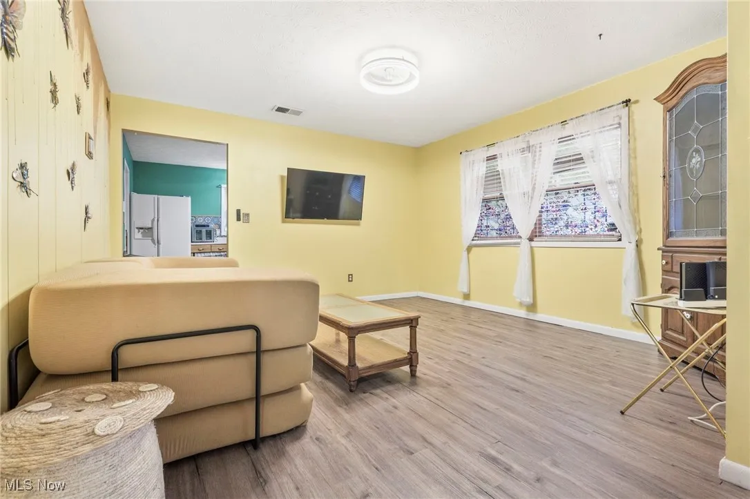 Living area with wood finished floors and baseboards