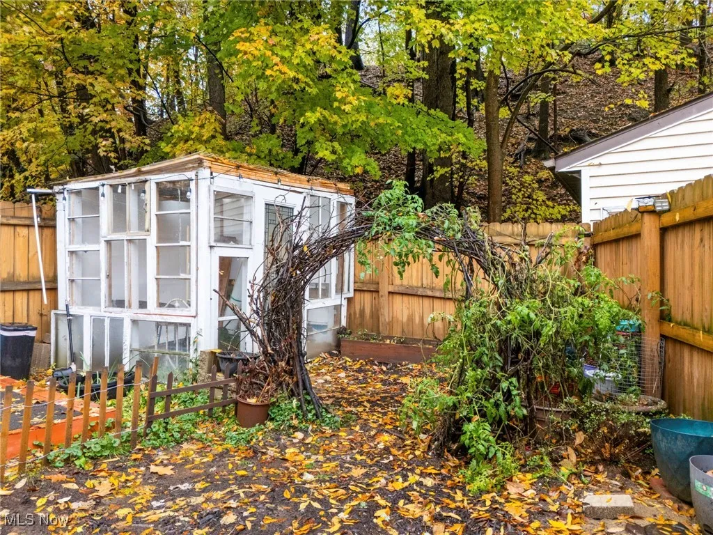 View of outbuilding with a fenced backyard and a sunroom