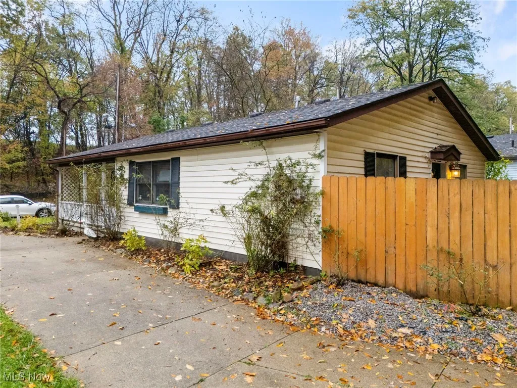 View of side of property with a shingled roof