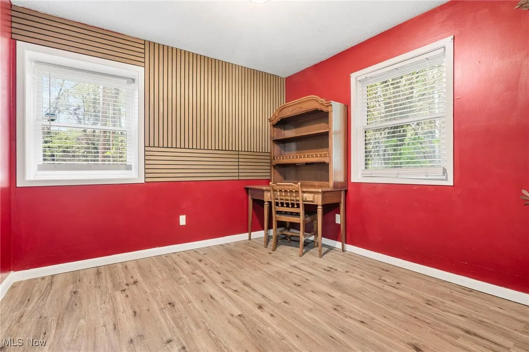 Home office with wood finished floors and baseboards