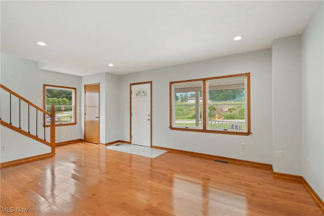 Foyer entrance featuring stairway, light wood-style floors, and recessed lighting