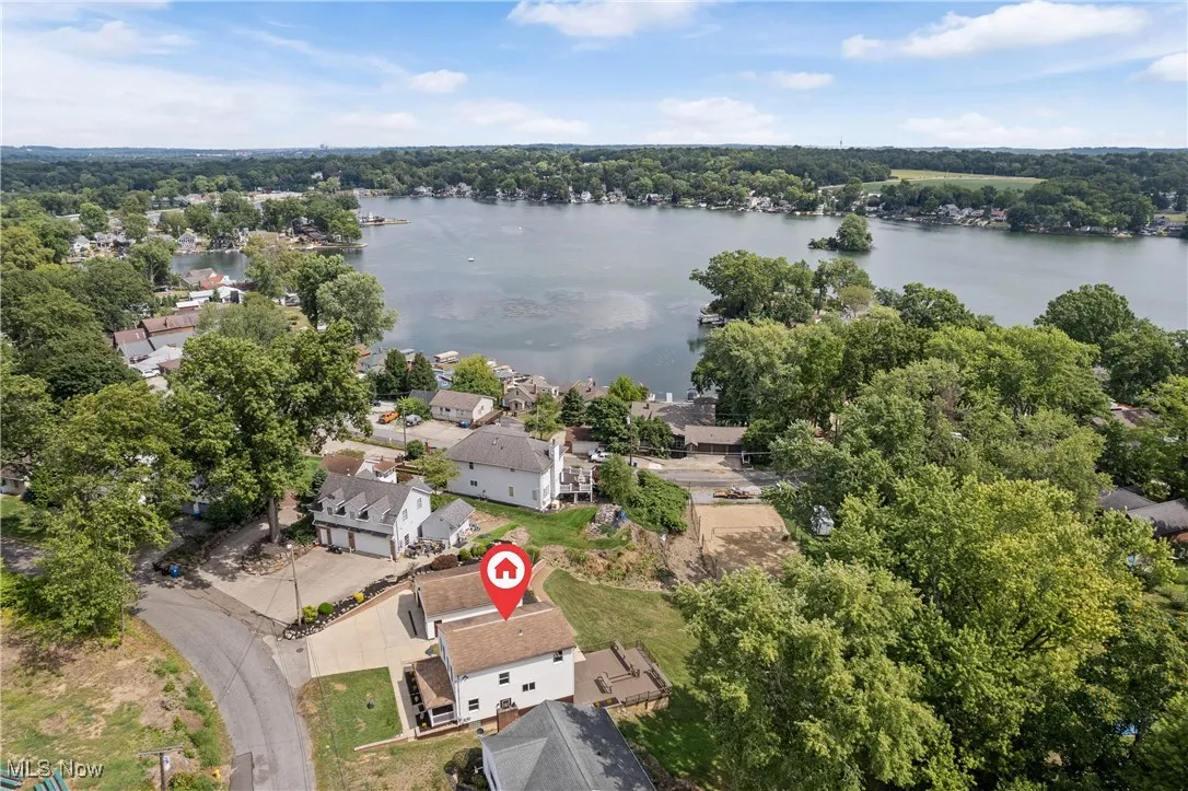 Aerial view of residential area featuring a large body of water