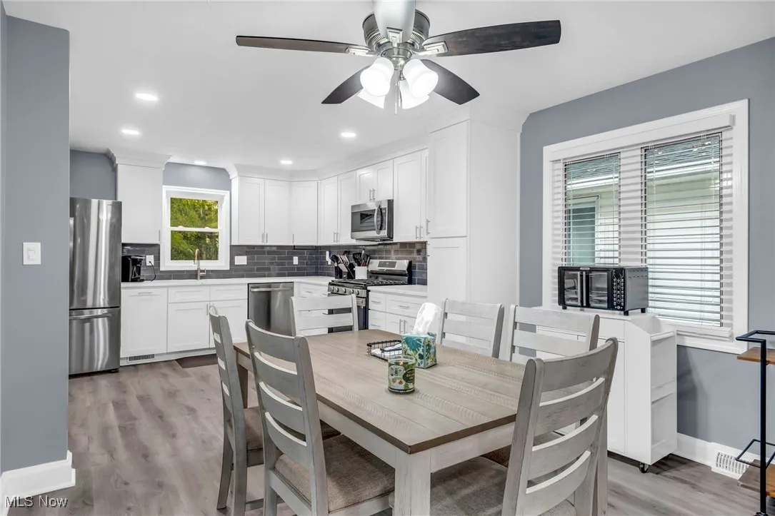 Dining room featuring light wood finished floors, recessed lighting, and ceiling fan