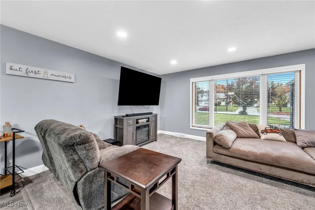 Living room with recessed lighting and light colored carpet