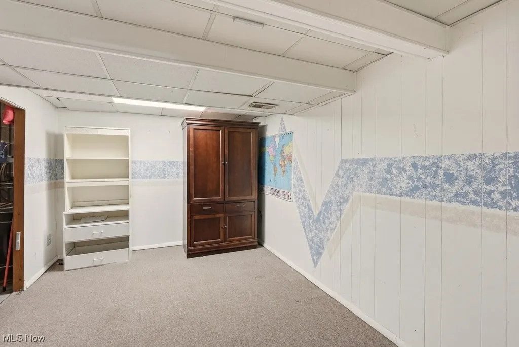 Unfurnished denwith light colored carpet