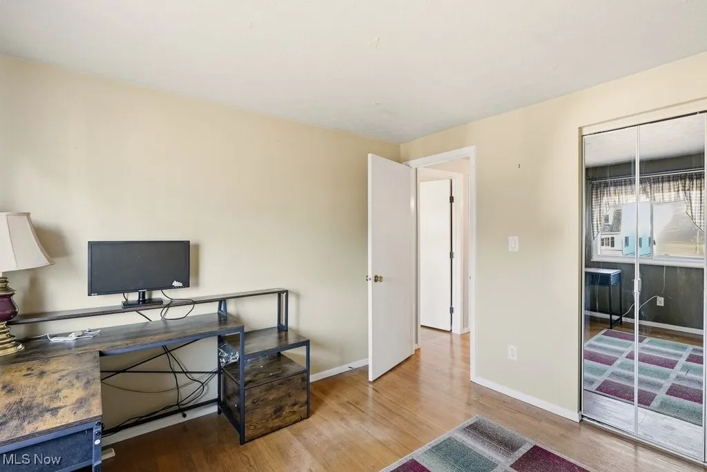 Office area with light wood-type flooring and baseboards