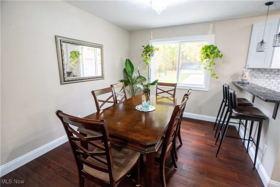 Dining room featuring baseboards and dark wood finished floors