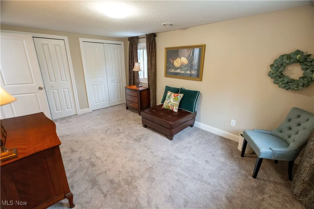 Upstairs en-suite. featuring light carpet and baseboards