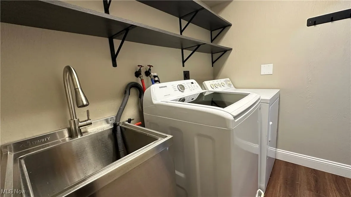 Washroom featuring dark wood finished floors and separate washer and dryer