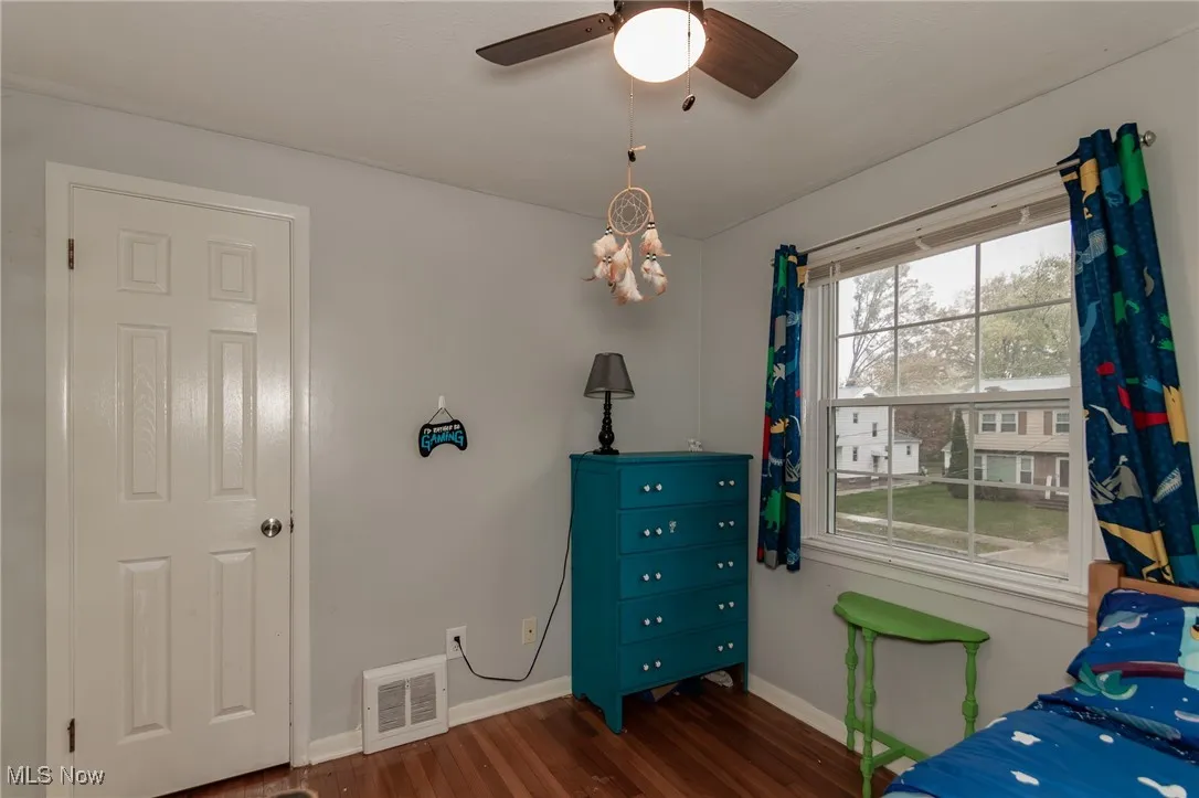 Bedroom featuring dark wood-style flooring and ceiling fan