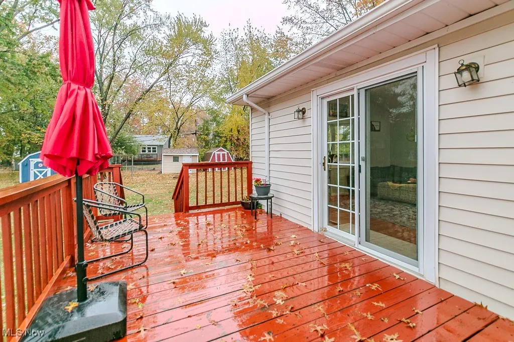 Wooden terrace featuring a shed