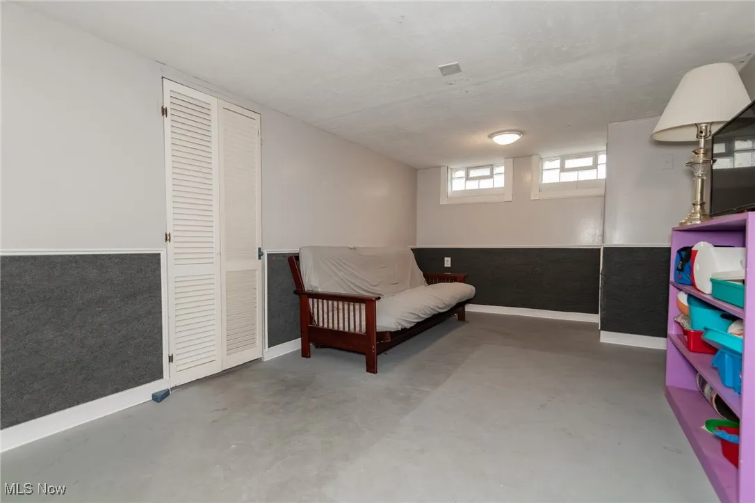 Sitting room with concrete floors and baseboards