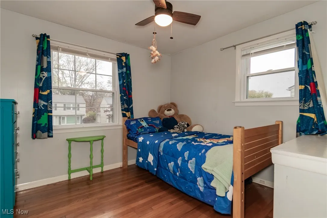 Bedroom featuring dark wood-style flooring and ceiling fan