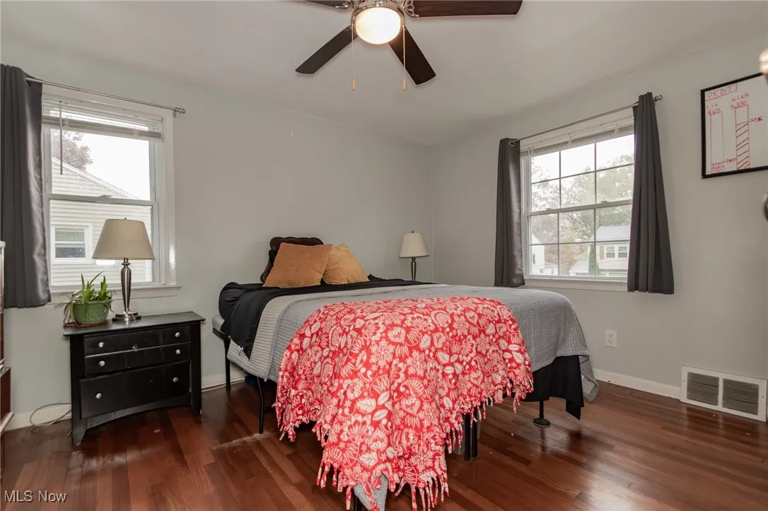 Bedroom with dark wood-type flooring and ceiling fan