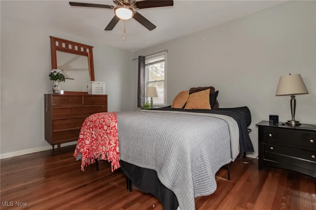 Bedroom featuring dark wood-style flooring and ceiling fan