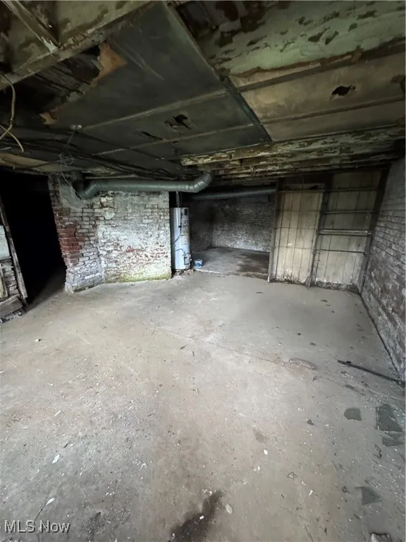 Unfinished basement featuring water heater