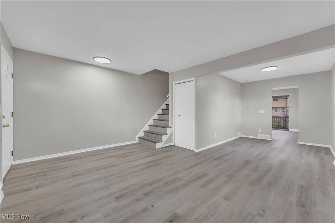Below grade area with stairs and light wood-style floors