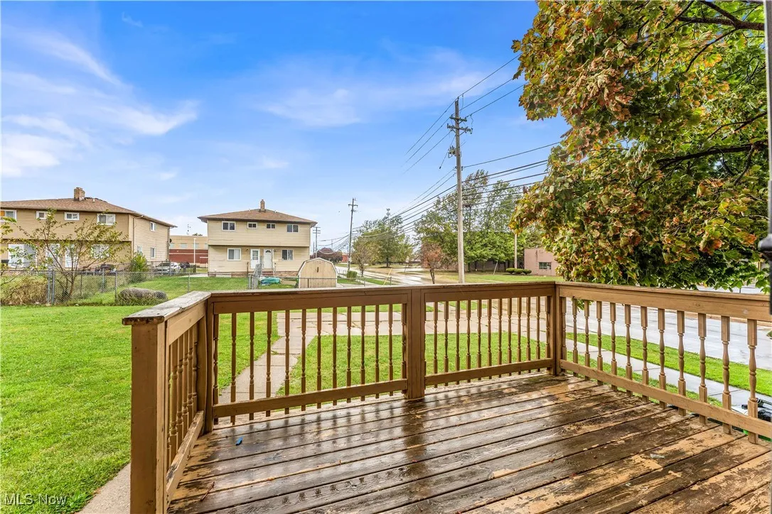 Deck with a shed, a residential view, and a fenced backyard