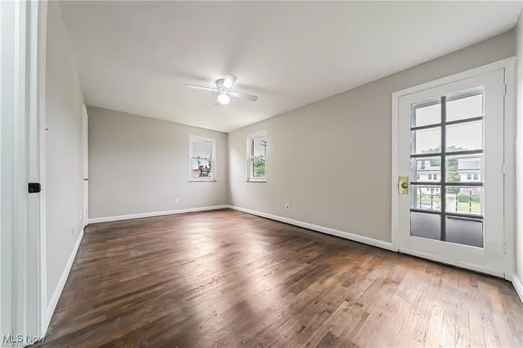 Unfurnished room featuring wood finished floors and ceiling fan