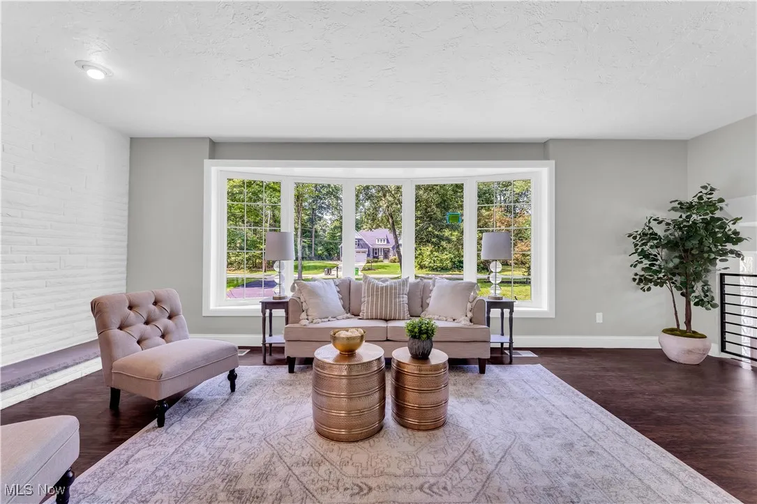 Living room with healthy amount of natural light, wood finished floors, and a textured ceiling