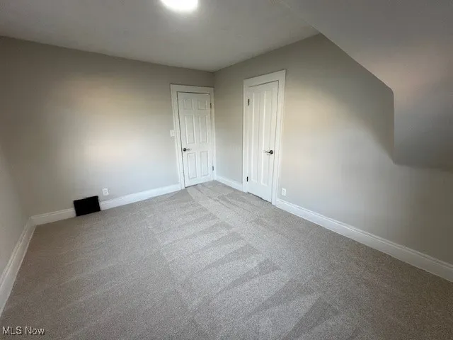 Bonus room with carpet and baseboards