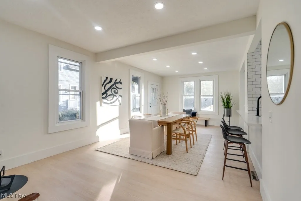 Dining room with recessed lighting, light wood-style floors, and beam ceiling