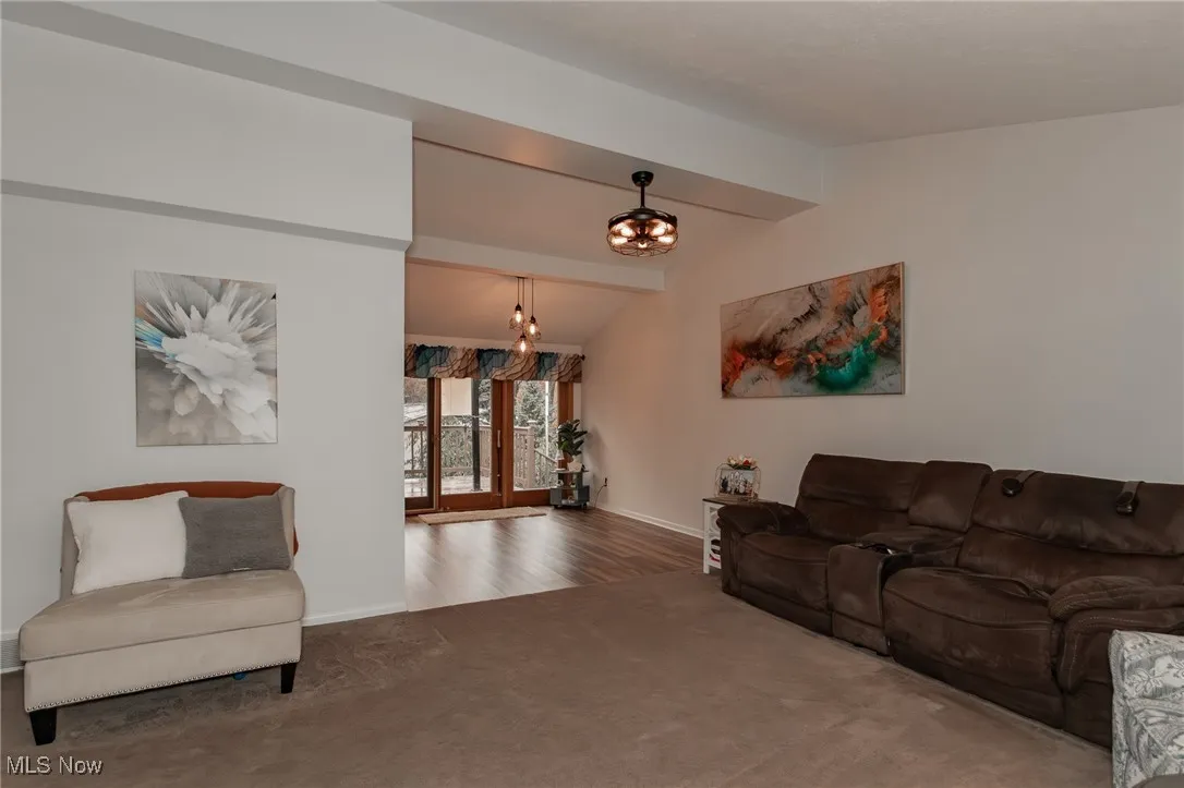 Living room with carpet flooring and a chandelier