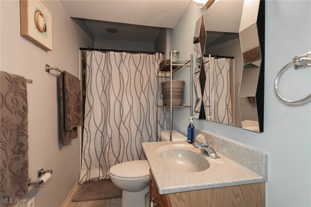 Bathroom with curtained shower and vanity