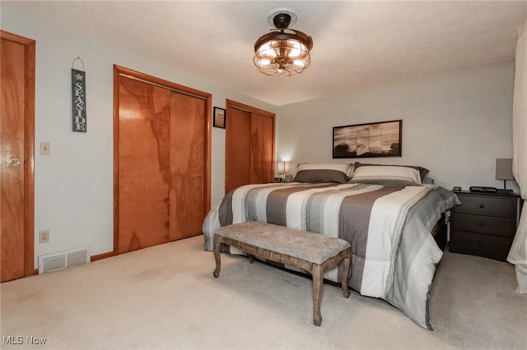 Bedroom featuring two closets and carpet floors
