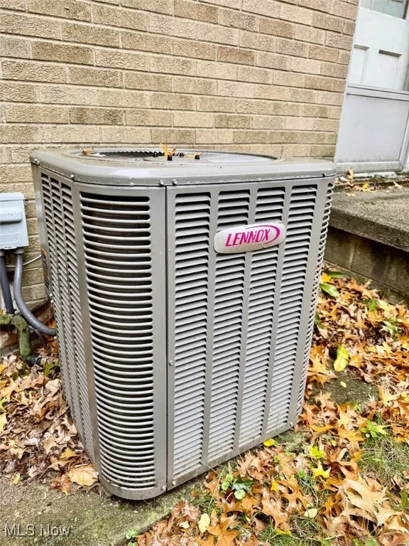 Exterior view of a cooling unit and brick siding