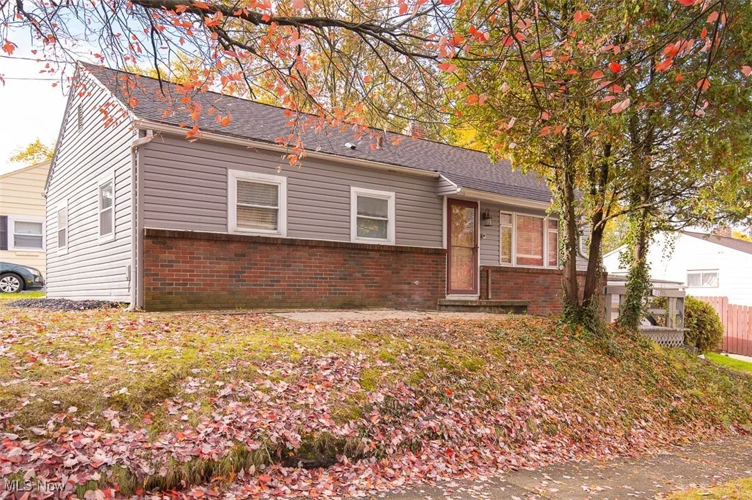 View of front of property featuring brick siding and a shingled roof