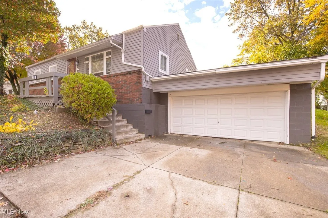 View of front of home with concrete driveway and brick siding