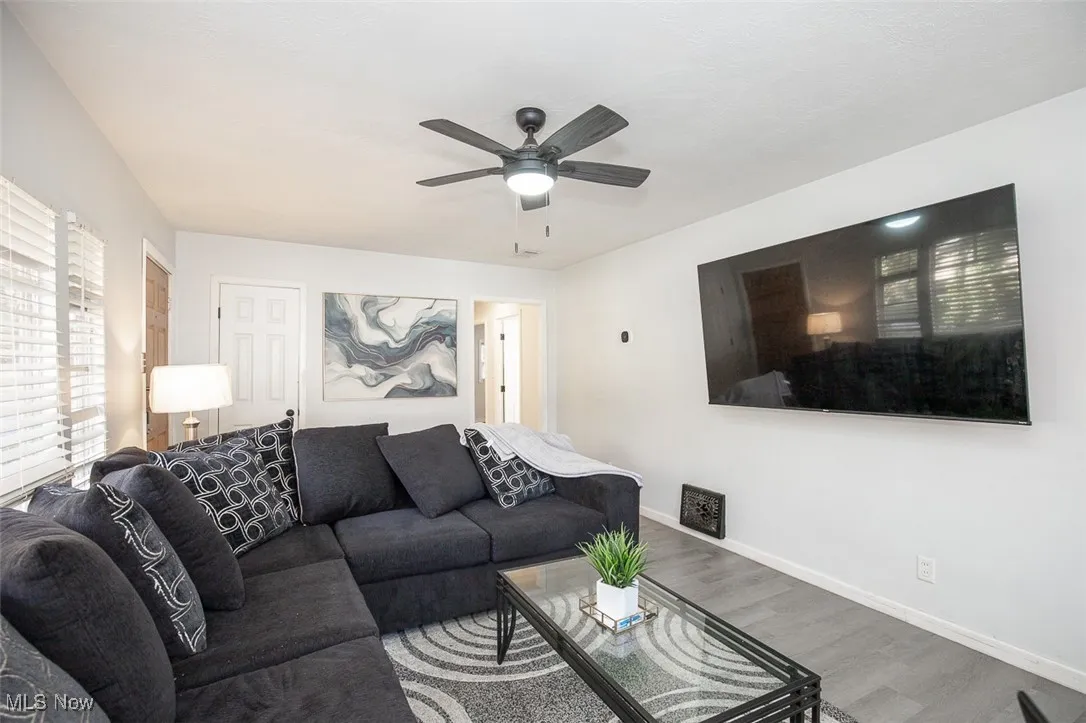 Living room with wood finished floors and ceiling fan