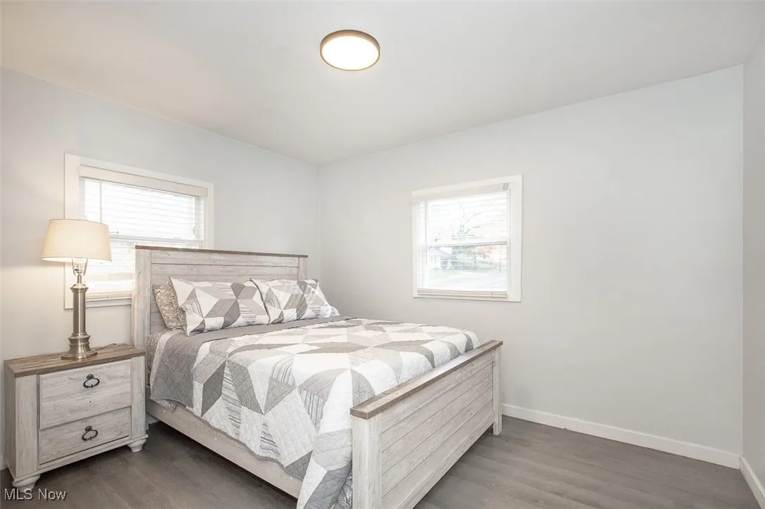 Bedroom featuring wood finished floors and baseboards