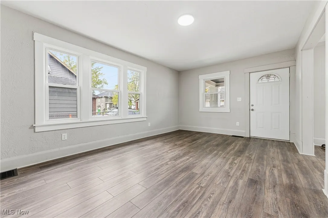 Entryway featuring dark wood-type flooring and healthy amount of natural light