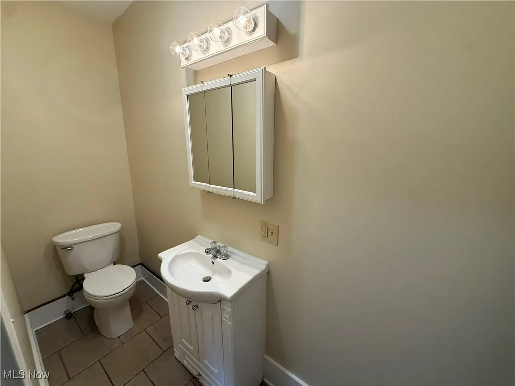 Bathroom featuring tile patterned flooring and vanity