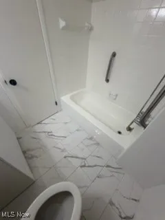 Full bathroom featuring shower / tub combination and toilet