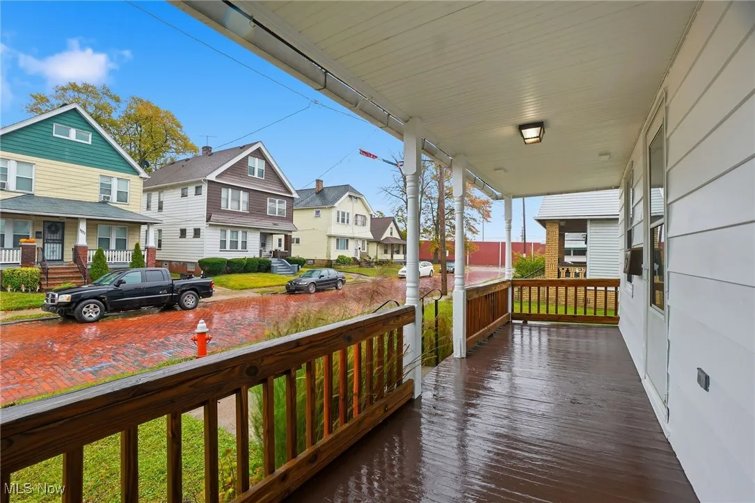 Wooden porch featuring a residential view