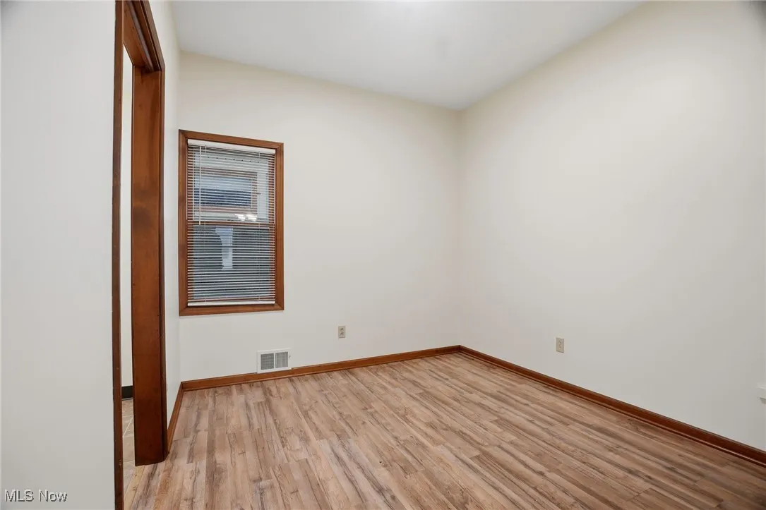 Spare room with light wood finished floors and baseboards