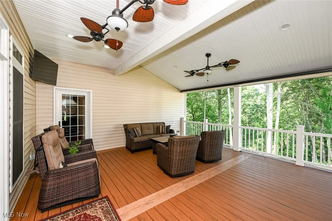 Deck featuring an outdoor living space and a ceiling fan