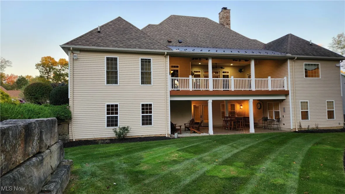 Rear of home showing walkout lower level and deck off main level.