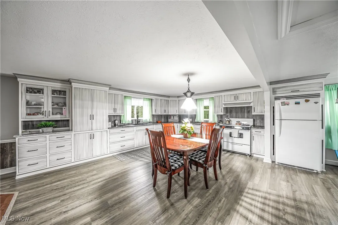 Dining area featuring a textured ceiling and light wood-style floors