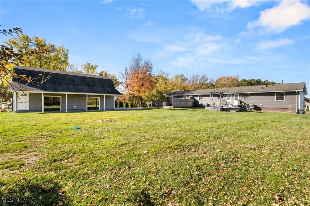 Back of property with a lawn