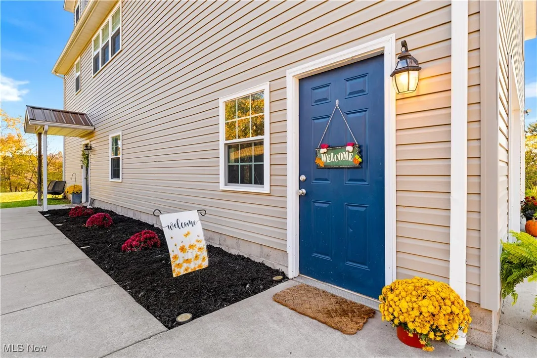 Sidewalk to front door and man door to garage