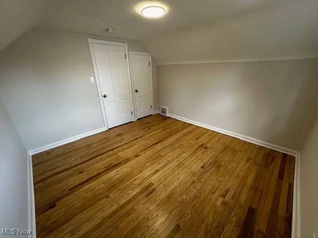 Bonus room featuring vaulted ceiling and wood finished floors