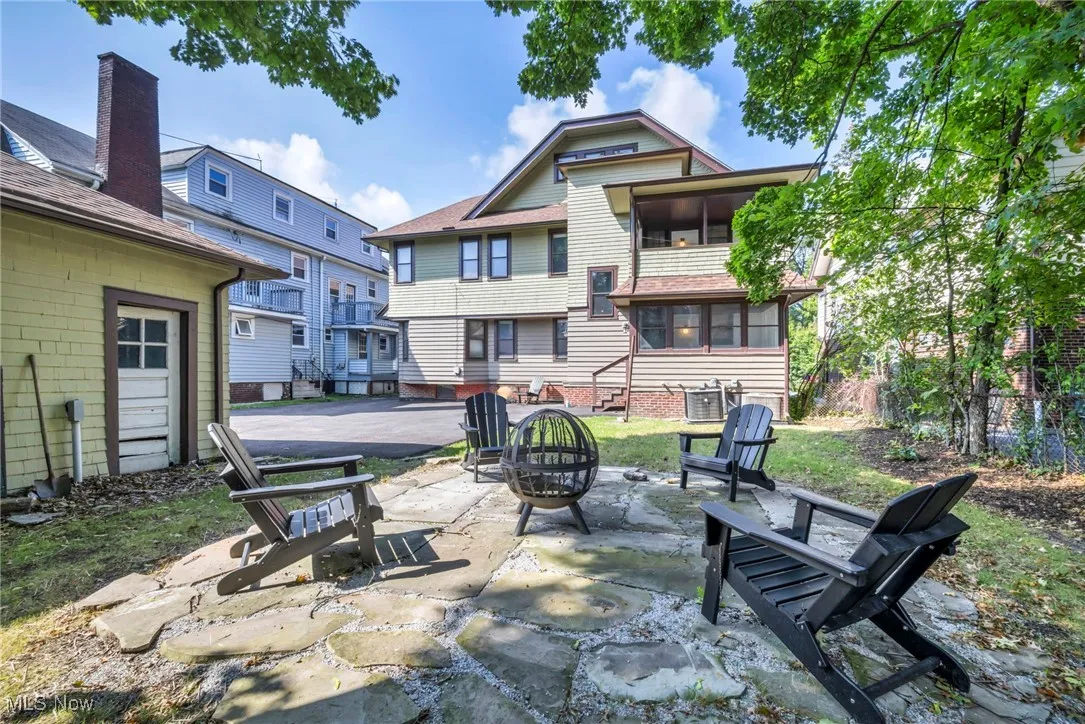 View of patio / terrace with an outdoor fire pit and a sunroom