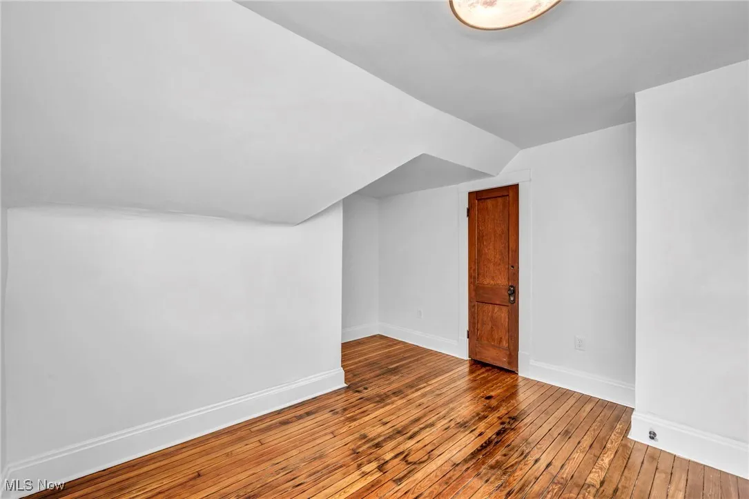 Bonus room featuring hardwood / wood-style flooring and lofted ceiling