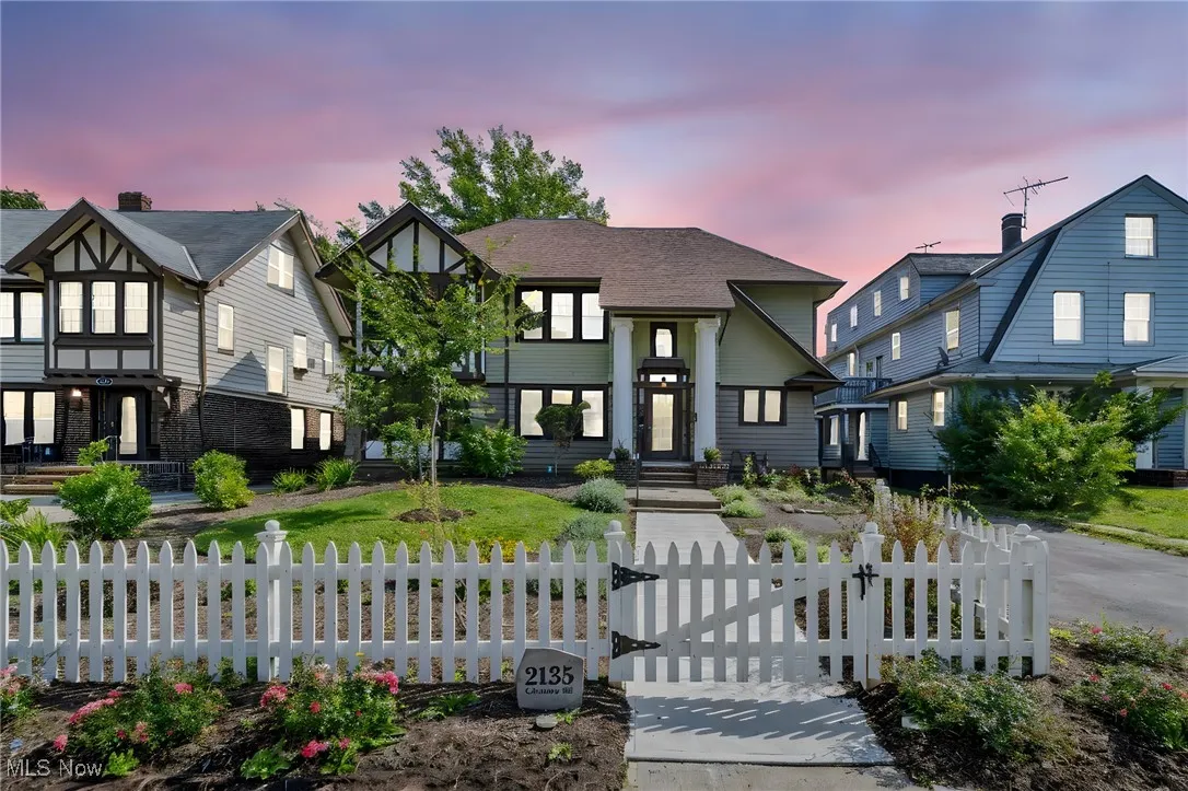 View of front of house featuring a fenced front yard and a gate