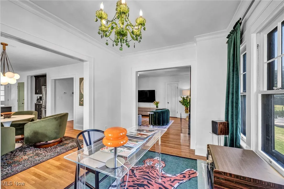 Dining area featuring a chandelier, crown molding, and wood finished floors